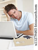 Young man working with laptop computer