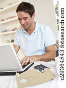 Young man working with laptop computer