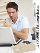 Young man working with laptop computer