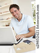 Young man working with laptop computer