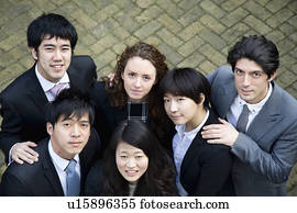 Multi ethnic business group looking up