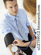 Young man having blood pressure taken Young man having blood pressure taken