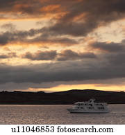 Yacht in the ocean at sunset, Santiago Island, Galapagos Islands, Ecuador