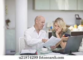 Couple paying their bills at home