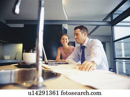 Couple relaxing in kitchen Couple relaxing in kitchen