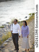 Senior Couple Walking by River