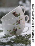 Three cups with Christmas imprint and fir branch