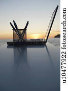 A laptop with a sun setting behind