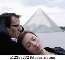 Couple relax outside the Louvre Couple relax outside the Louvre