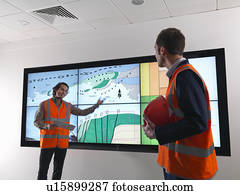 Oil workers with geology screen