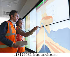 Oil workers with geology screen
