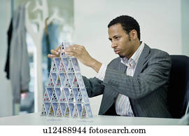 Businessman building house of cards