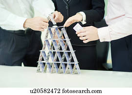 Businessman building house of cards