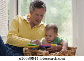Grandad reading grandson a story