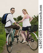 Happy couple prepare to bicycle Happy couple prepare to bicycle