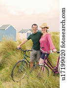 Happy couple with bicycles on beach Happy couple with bicycles on beach