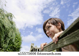 Woman looking over fence