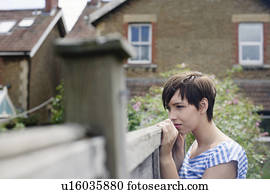 Woman looking over fence