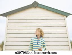 Boy against beach hut