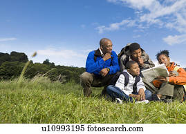 family hiking looking at map family hiking looking at map
