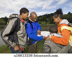 family hiking looking at map family hiking looking at map