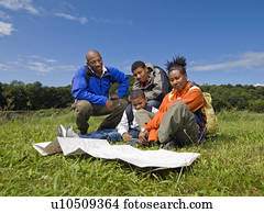 family hiking looking at map family hiking looking at map