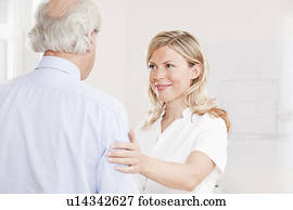 Old man and woman in a white lab coat
