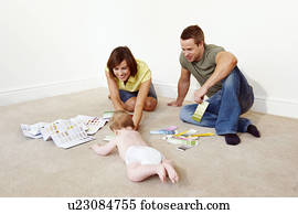 Young family on floor with color samples Young family on floor with color samples