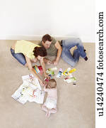 Young family on floor with color samples Young family on floor with color samples