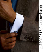 Business man adjusting cuff links