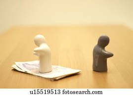 small figures, one on money