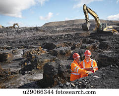Workers Inspecting Coal In Mine
