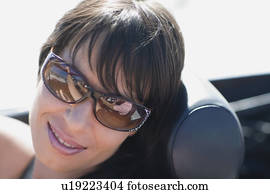 Woman with dark hair and big shades
