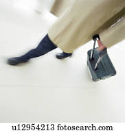 Business person rolling luggage