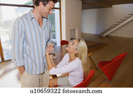 Smiling couple talking at home