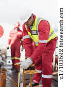 Worker turning wheel on oil rig Worker turning wheel on oil rig