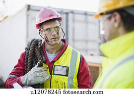Workers talking on oil rig Workers talking on oil rig