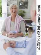 Smiling older couple playing cards