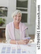 Smiling older woman playing cards