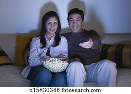 Couple watching tv on sofa