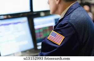 Stock trader with american flag on sleeve