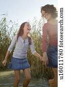 Mother and daughter walking in pond