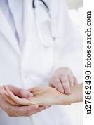 Close up of doctor taking patient's pulse