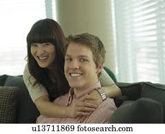 Young couple smiling in their home