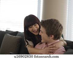 Young couple smiling in their home