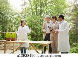 Business people talking with scientists