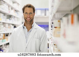 Pharmacist smiling in pharmacy