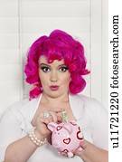 Portrait of a woman saving money in piggy bank