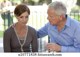 Absence seizure. Man looking after a woman who is having an absence seizure.