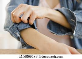 Woman rolling up sleeve